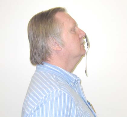 person hanging a spoon from their nose