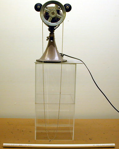 fan motor, pulley, a continuous loop of chain on a stand