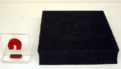 Magnet glued to Plexiglass holder, foam pad.