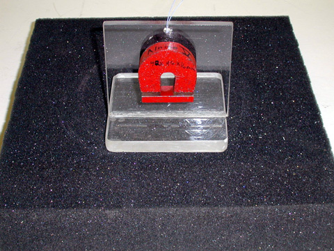 Magnet glued to Plexiglass holder, foam pad.
