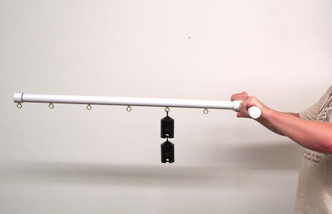 person gripping a torque bar horizontally; masses are hung on the bar on a hook near the handles