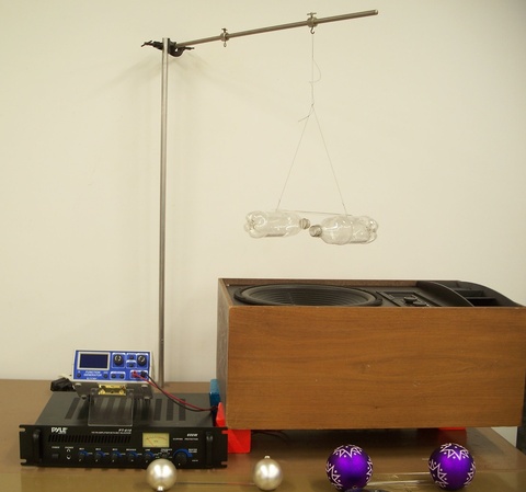 Soda Bottles hanging over a large speaker - 1Q40.89a.jpg