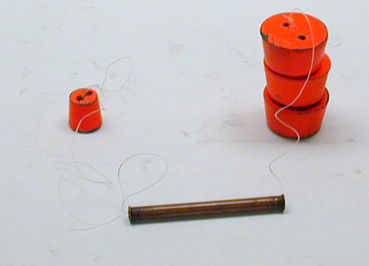 String through tube with three unequal masses,