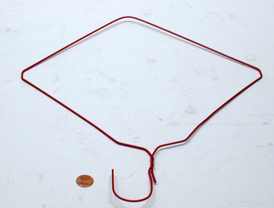 Coat hanger bent in to a "square" form, coin