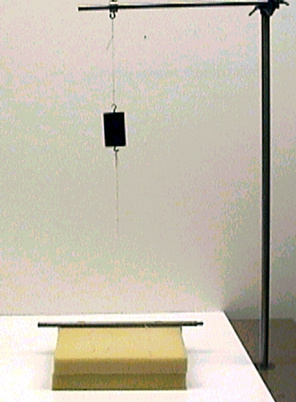 mass attached to a string on a handle, foam pads