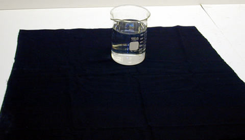 Beaker filled with water, black table cloth