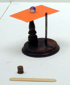 Inertia App., note card, pennies, tongue depressor.