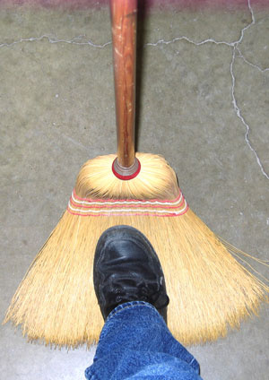 Stepping on the bristles of a broom