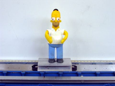 Homer figure on an air track car