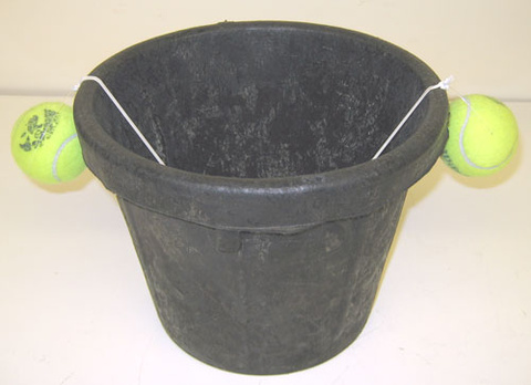 tennis balls on a string in a bucket