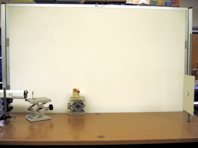 Laser, beam splitter, Radio shack speaker amplifier with photocell, mirror with magnetic backing, metal "wall".