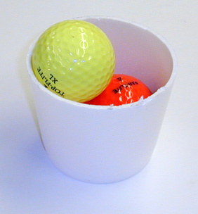 two golf balls in a Styrofoam cup