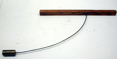 Wood stick with weight on curved wire