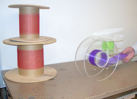 Spools of different diameters with rope or ribbon wound on the spindle