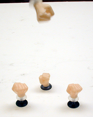 Spring loaded suction cup hands