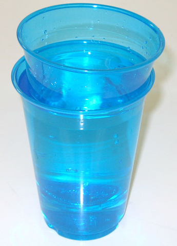One plastic cup floating in another plastic cup 