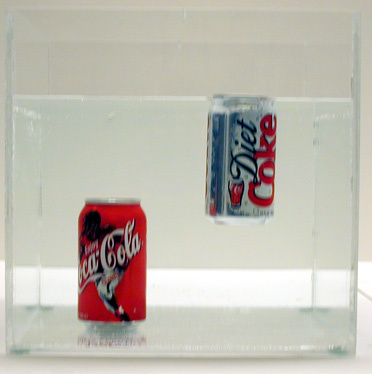 Can of Regular Soft (i.e. Pepsi, Coke) and Can of Diet soft drink in water