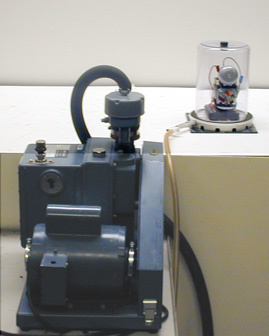 Bell jar with sorbothane pad, vacuum pump, 6 volt battery with attached doorbell.