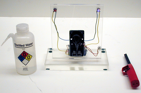 Bimetal strip thermometer apparatus, grill lighter, distilled water.