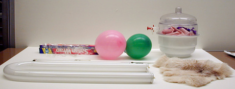 Fluorescent light, balloons, silk, cats fur, Saran Wrap