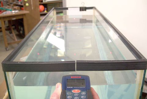 Laser Tape Measure Pointed at Note Card in Air