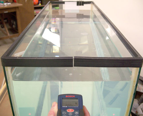 Laser Tape Measure Pointed at Note Card in Water