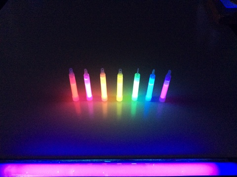 three light sticks under black light