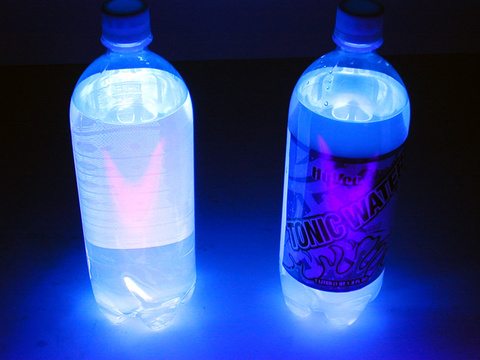 bottles of tonic water under black light