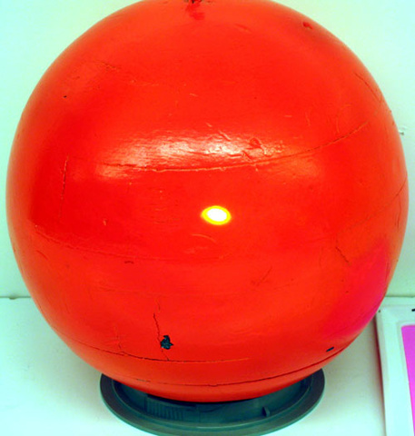 orange sphere with yellow dot of light