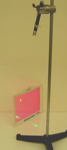 laser pointer on a stand, pointing at a fluorescent sheet