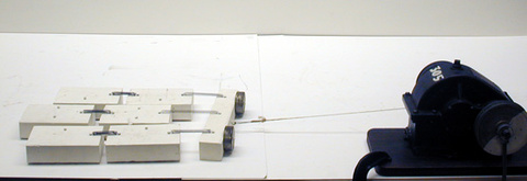 Earthquake model blocks and springs, pulled apart; gear drive