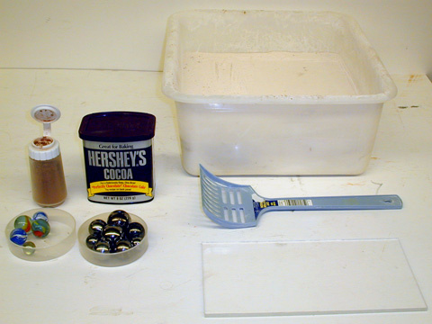 Milk Drop Slides (Stroboscopic Photography Section of the Slide Files), Plastic Dish Pan, White Flour, Granulated Sugar, Ball Bearings, Plexiglas Smoothing Plate, and Cocoa or Cinnamon Powder.